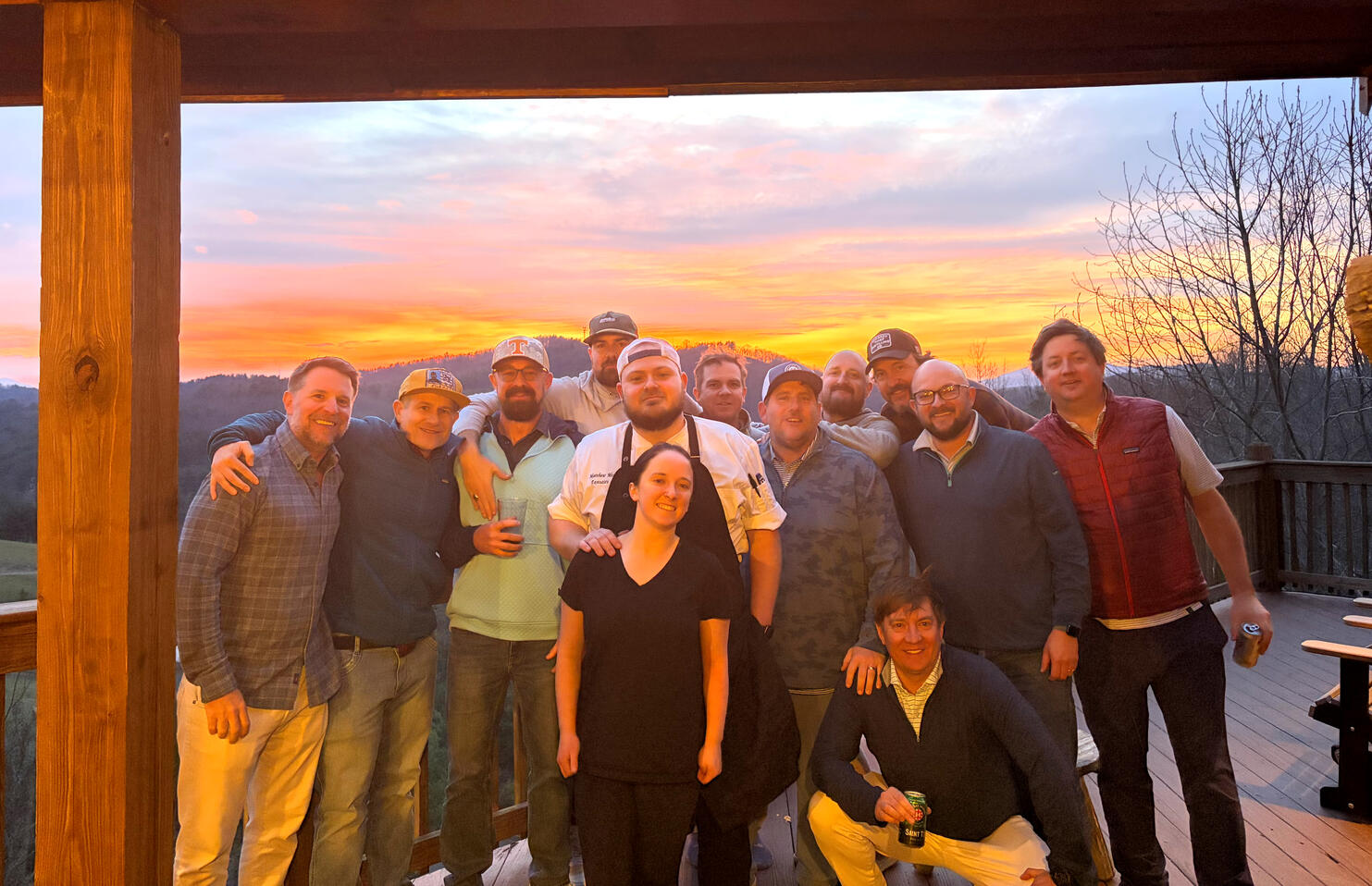 Chef Matthew Meehan with a 12-guest private dining group at a mountain retreat in the NC High Country